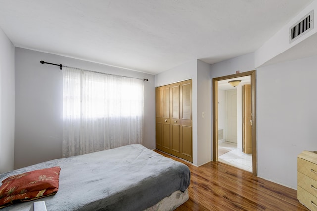 bedroom featuring a closet and light hardwood / wood-style floors