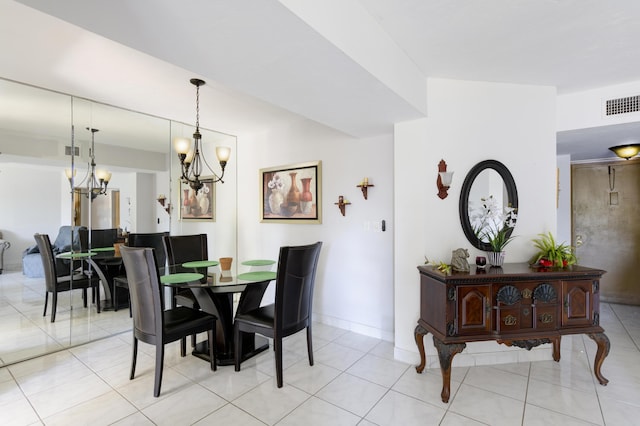 dining space featuring light tile patterned floors and an inviting chandelier