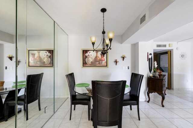 tiled dining space featuring an inviting chandelier