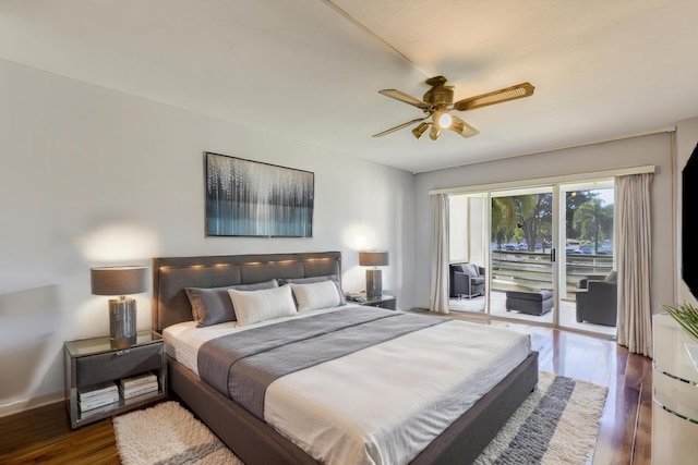 bedroom with dark hardwood / wood-style floors, ceiling fan, and access to outside