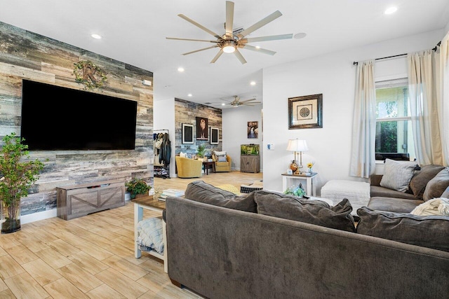 living room featuring light wood-type flooring and ceiling fan