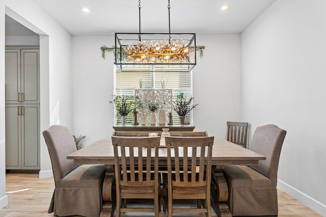 dining room featuring light hardwood / wood-style floors and a notable chandelier