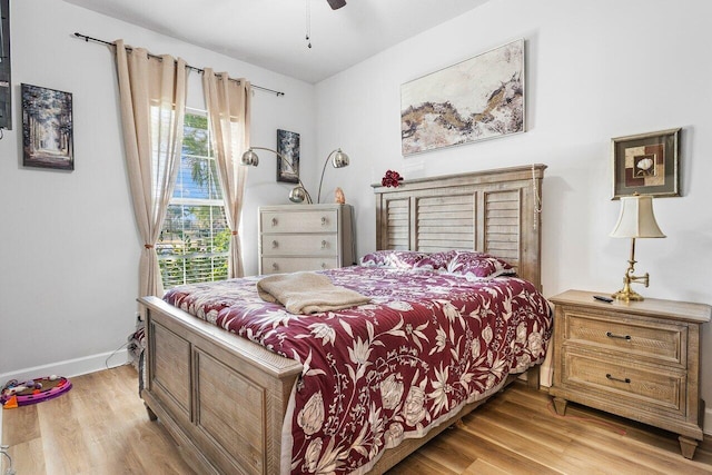 bedroom with ceiling fan and light hardwood / wood-style floors