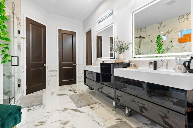 bathroom with vanity, an enclosed shower, and tile walls