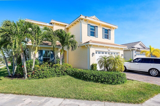 view of front of house featuring a front yard and a garage