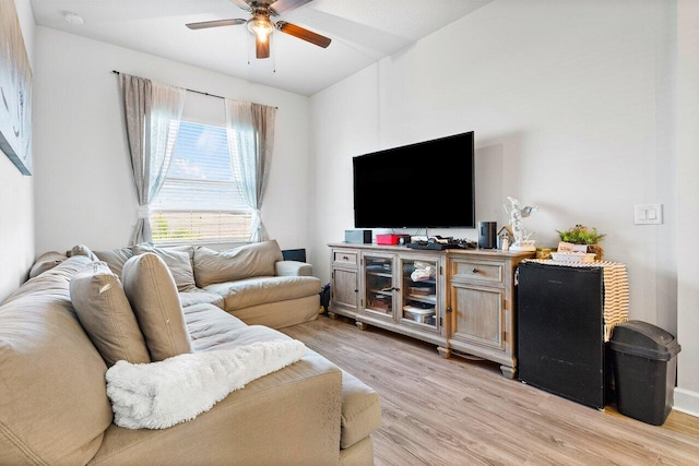 living room featuring ceiling fan and light hardwood / wood-style flooring