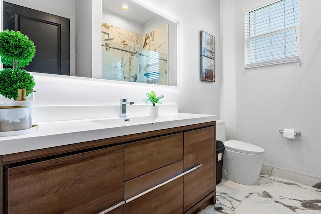 bathroom featuring toilet, vanity, and walk in shower