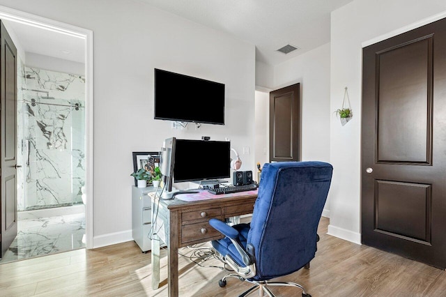 office with light wood-type flooring