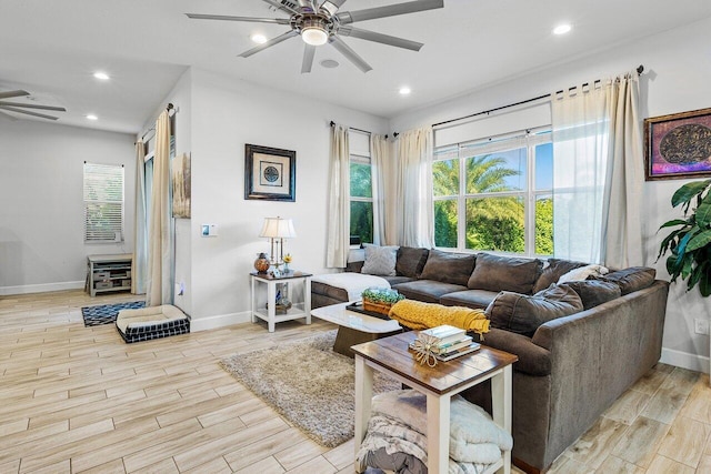 living room featuring ceiling fan, light hardwood / wood-style flooring, and a healthy amount of sunlight