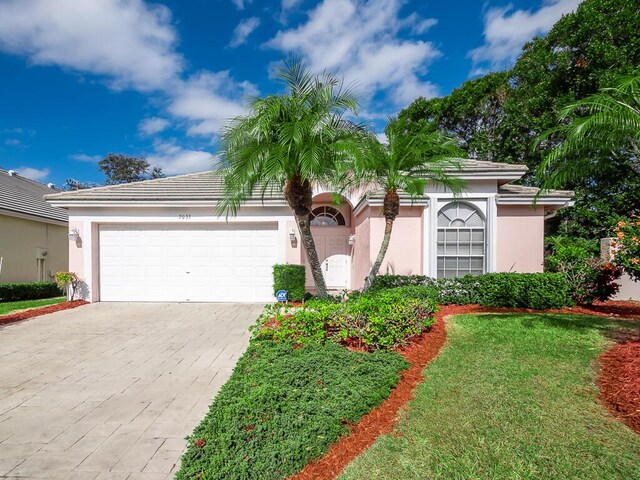 view of front of property featuring a yard and a garage