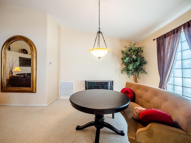 living area with carpet flooring and vaulted ceiling