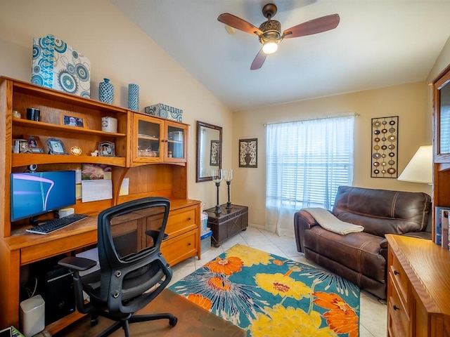 office area with light tile patterned floors, vaulted ceiling, and ceiling fan