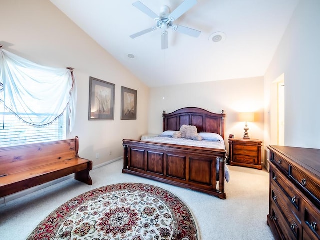 bedroom with ceiling fan, light colored carpet, and vaulted ceiling