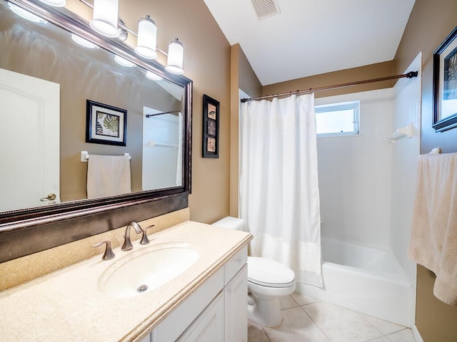 full bathroom featuring tile patterned flooring, vanity, toilet, and shower / tub combo with curtain