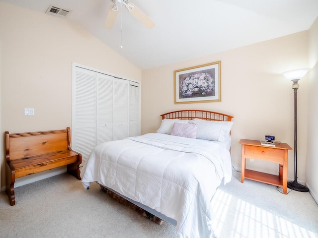 carpeted bedroom featuring a closet, ceiling fan, and lofted ceiling