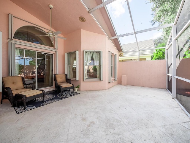 view of patio with glass enclosure and ceiling fan