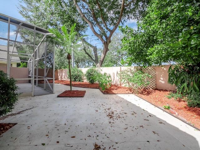 view of patio with glass enclosure