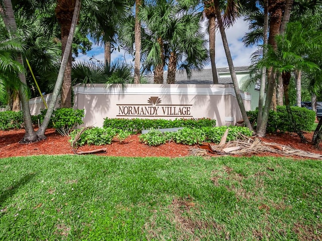 community / neighborhood sign with a lawn