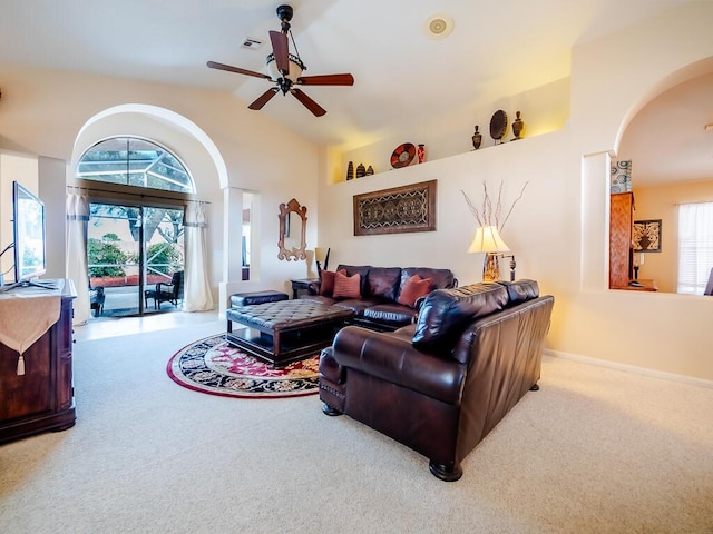 carpeted living room with high vaulted ceiling and ceiling fan