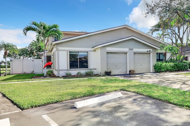 view of front of property with a front yard and a garage