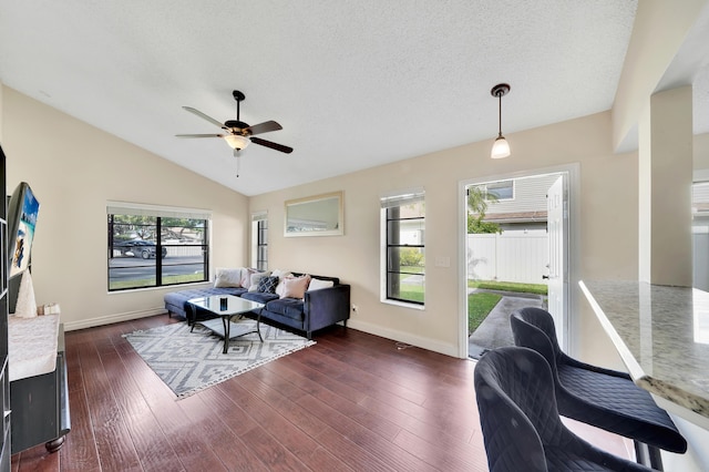 living room featuring dark hardwood / wood-style floors, ceiling fan, a textured ceiling, and vaulted ceiling