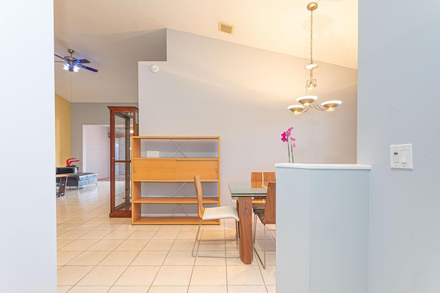 interior space featuring ceiling fan with notable chandelier and high vaulted ceiling