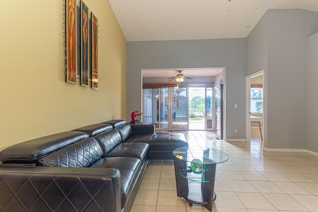 tiled living room with ceiling fan and lofted ceiling