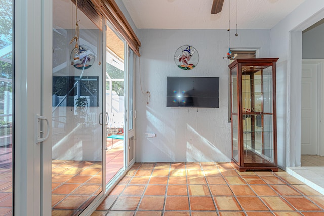 interior space with french doors, a textured ceiling, and ceiling fan