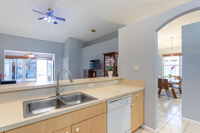 kitchen featuring sink, white dishwasher, a textured ceiling, light brown cabinetry, and light tile patterned flooring