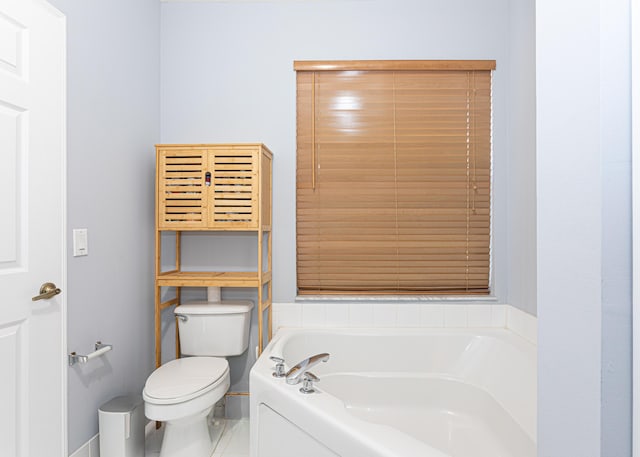 bathroom with a tub to relax in, tile patterned flooring, and toilet