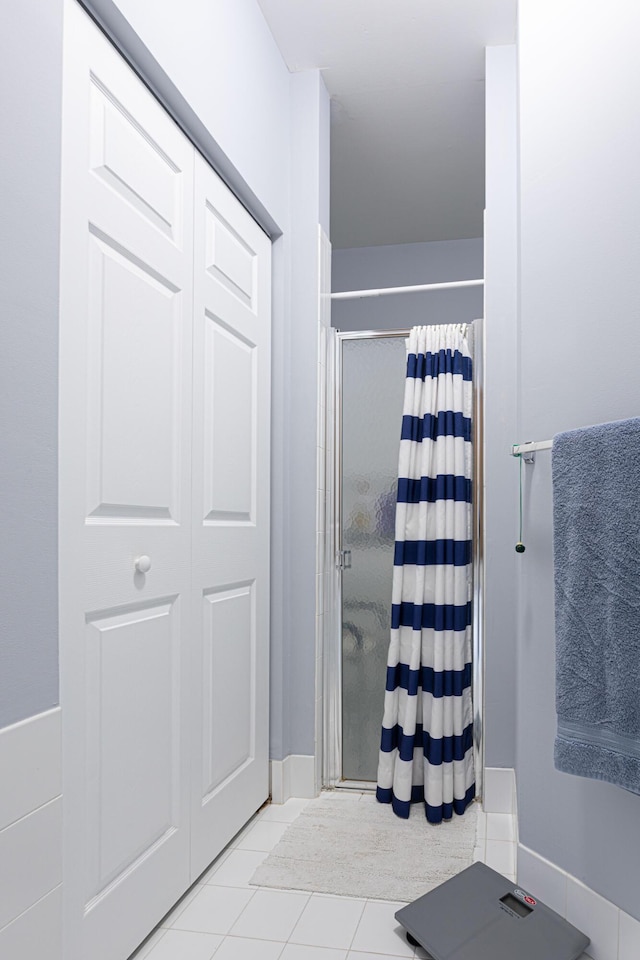 bathroom featuring tile patterned floors and a shower with curtain