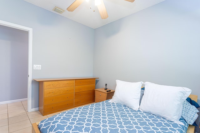 bedroom featuring tile patterned floors, ceiling fan, and a textured ceiling