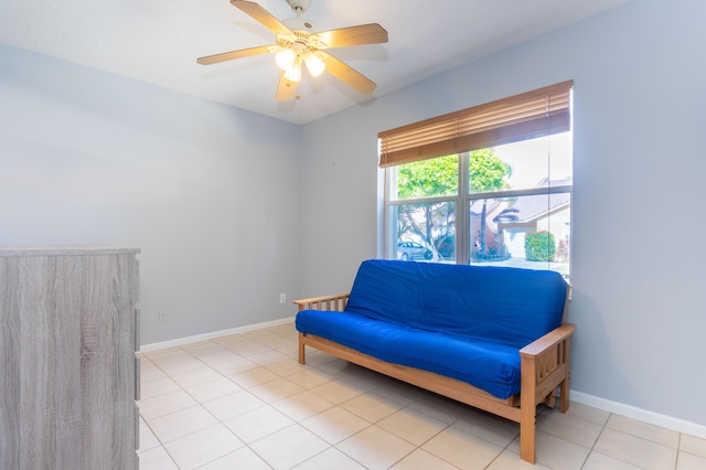 living area featuring light tile patterned floors and ceiling fan