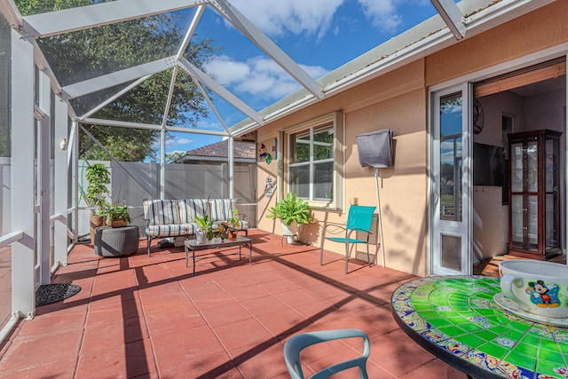 view of patio featuring outdoor lounge area and glass enclosure