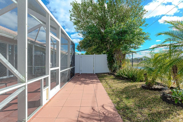 view of patio with glass enclosure