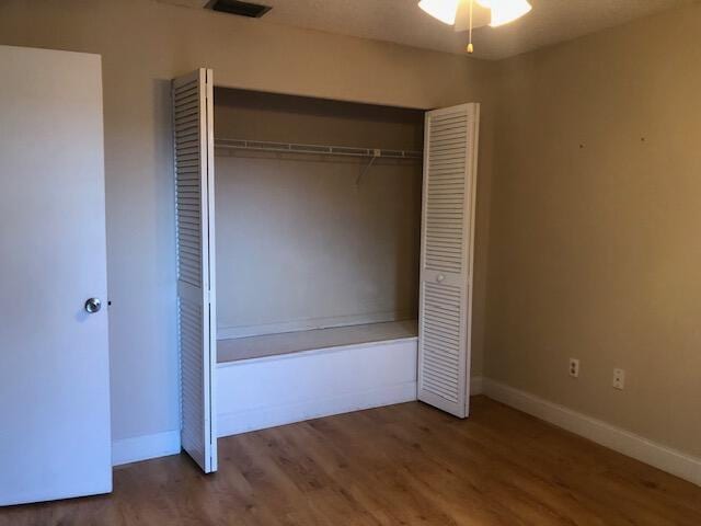 unfurnished bedroom featuring a closet and wood-type flooring