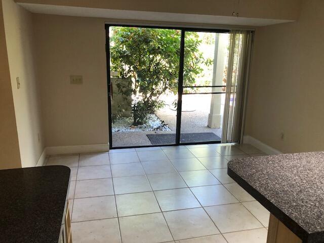 entryway with light tile patterned flooring