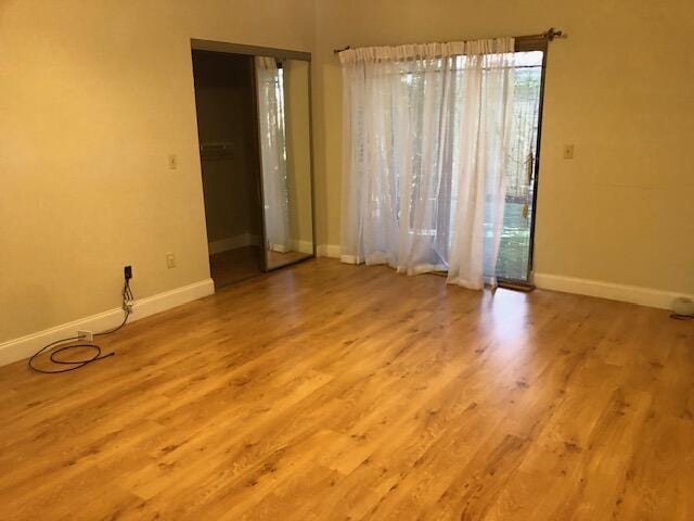 unfurnished room featuring plenty of natural light and light hardwood / wood-style floors