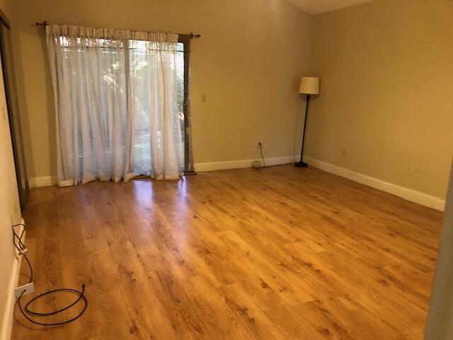 spare room with hardwood / wood-style floors