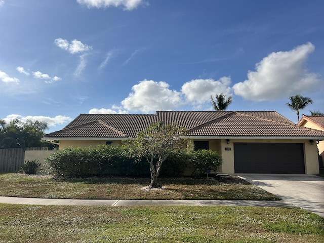 view of front facade with a front yard and a garage