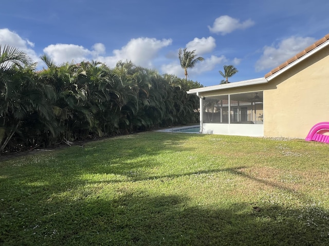 view of yard with a sunroom