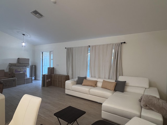 living room with hardwood / wood-style floors and lofted ceiling