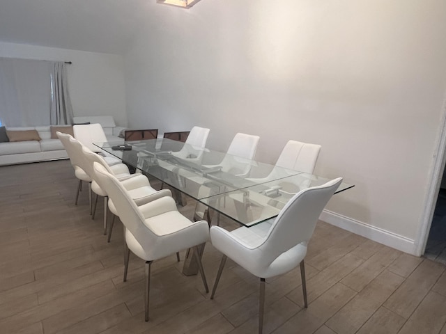 dining space with wood-type flooring