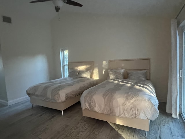 bedroom with ceiling fan and dark hardwood / wood-style flooring