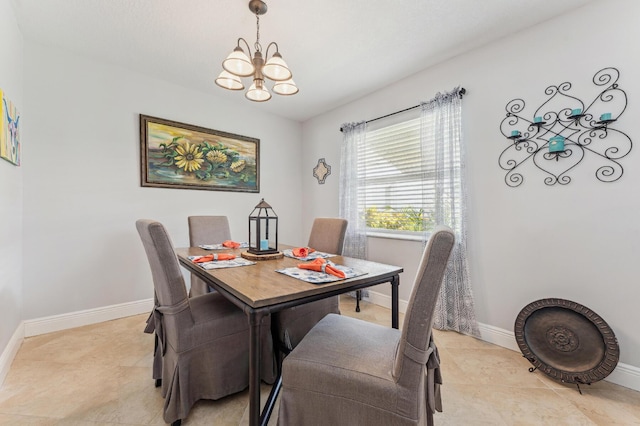 dining area with a notable chandelier and light tile patterned floors