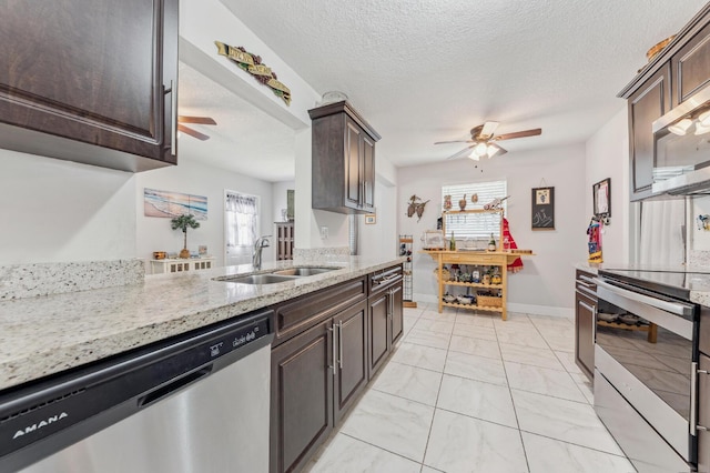 kitchen with a textured ceiling, stainless steel appliances, a wealth of natural light, and sink