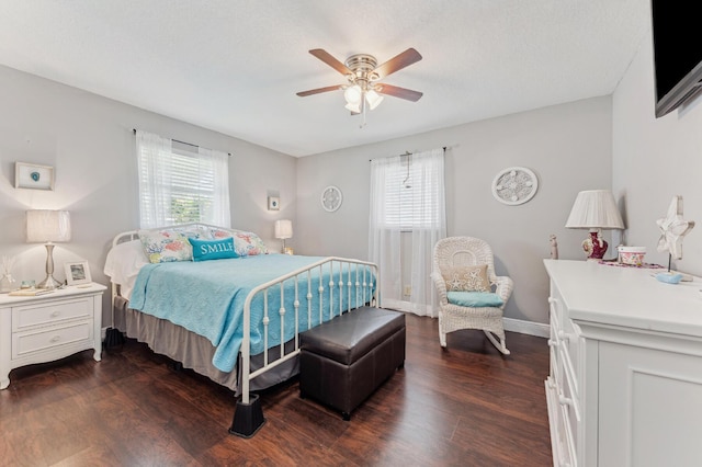 bedroom with ceiling fan, dark hardwood / wood-style flooring, and multiple windows