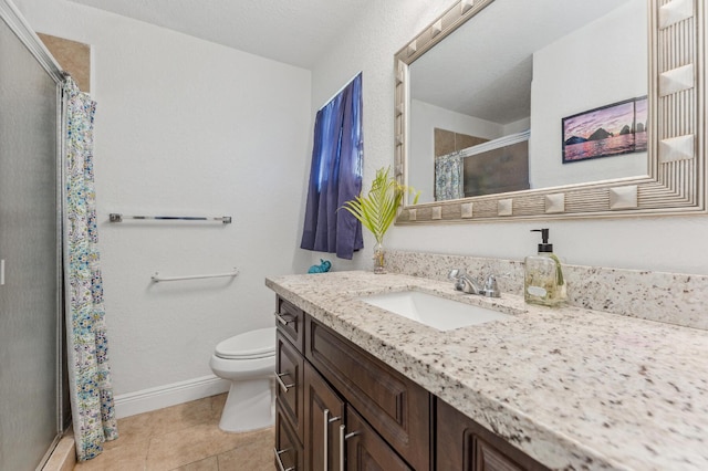 bathroom with tile patterned flooring, a textured ceiling, vanity, and toilet