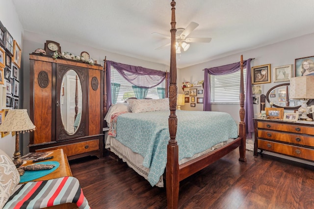 bedroom featuring multiple windows, dark wood-type flooring, and ceiling fan