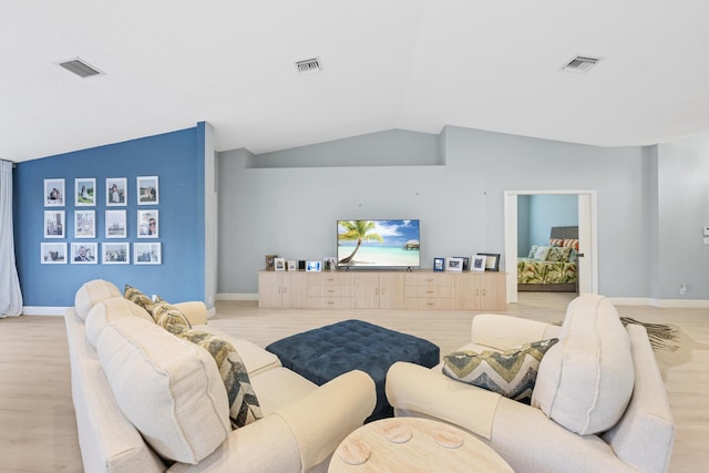 living room featuring light wood-type flooring and lofted ceiling